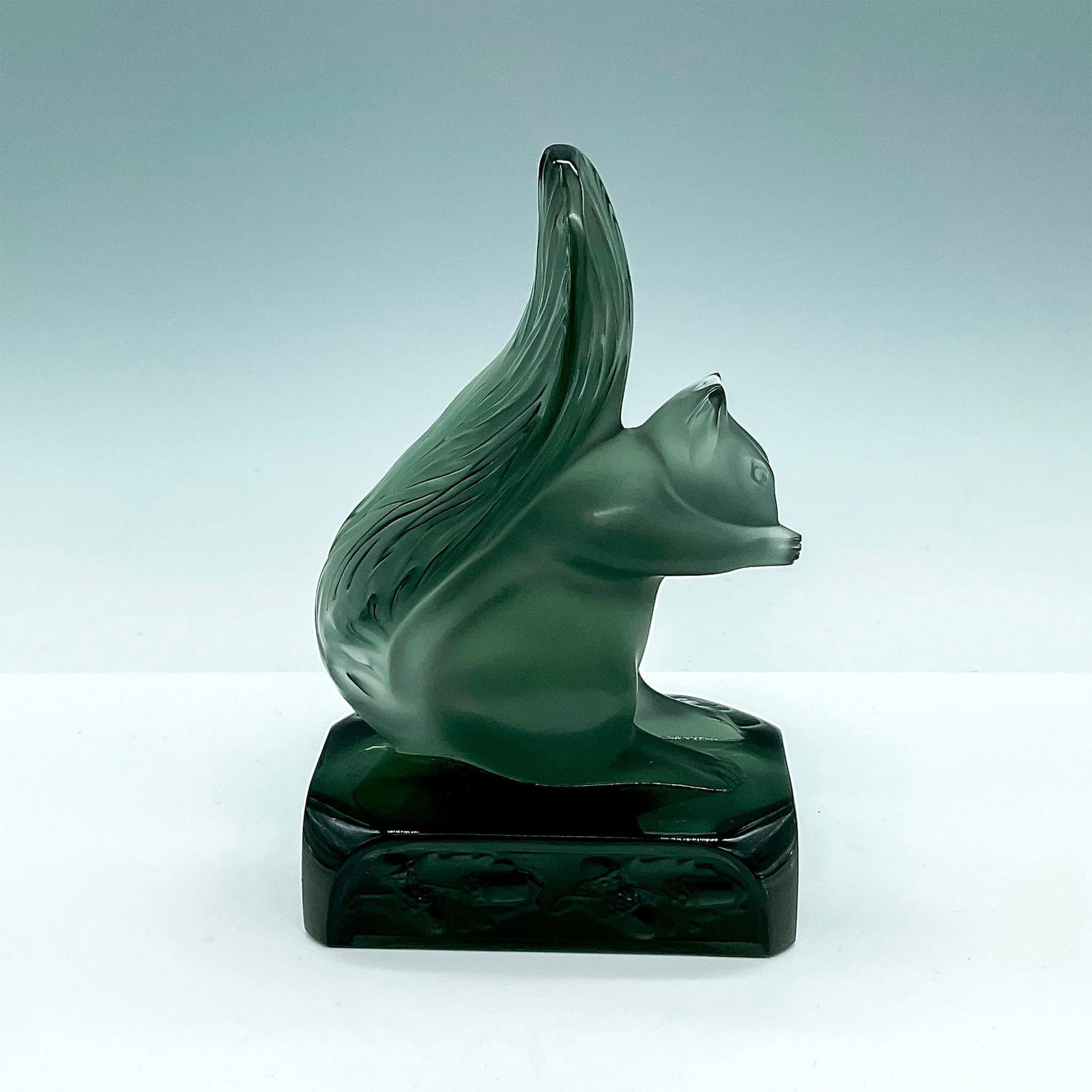 Lalique Crystal Gray Sculpture, Grisolin: A satin finished squirrel atop of a clear and frosted base adorned in acorn design. Lalique France etched on base. Dimensions: 4"L x 2.75"W x 6"H Manufacturer: Lalique Country of Origin: France Proven
