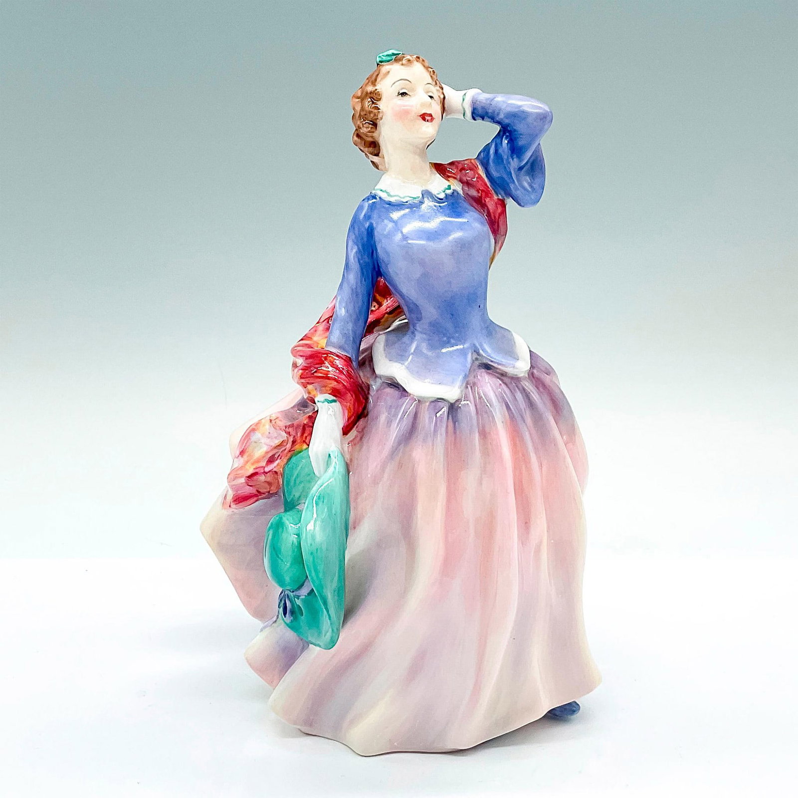 Blithe Morning HN2021 - Royal Doulton Figurine: A figure of a woman in a pink and mauve dress, holding a green wide brim hat. Royal Doulton backstamp. Artist: Leslie Harradine Issued: c. 1949-1971 Dimensions: 5"L x 4.5"W x 6.75"H Manufacturer: Roya