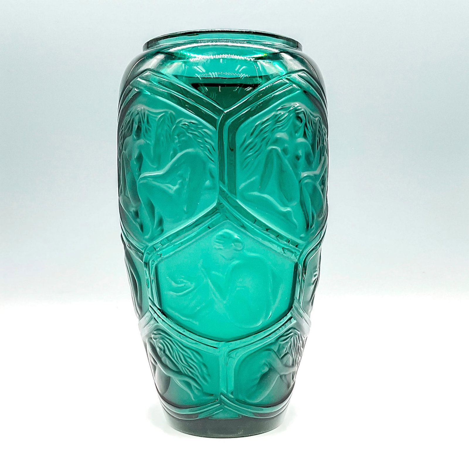 Lalique Crystal Vase, Green, Hesperides: Elegant vase in teal green with frosted honeycomb of panels depicting nude figures inside each one. Signed on bottom Vert De Lune and Lalique, France. Dimensions: 5"L x 3"W x 9"H Manufacturer: Lalique