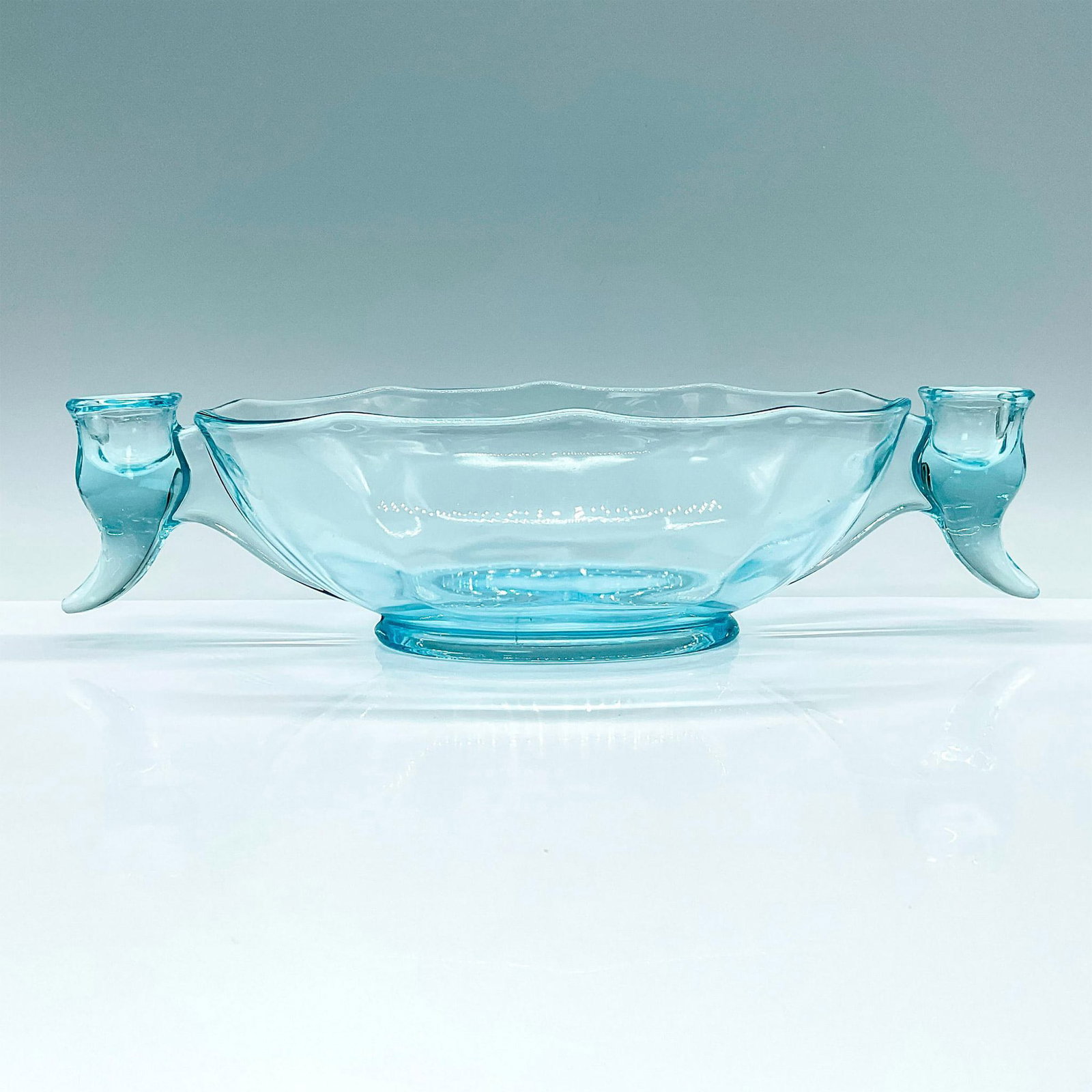 Fostoria Blue Glass Candle Bowl: Beautiful iridescent blue glass scallop edged bowl with candle holders on each side. Dimensions: 13"L x 7"W x 3.5"H Country of Origin: USA