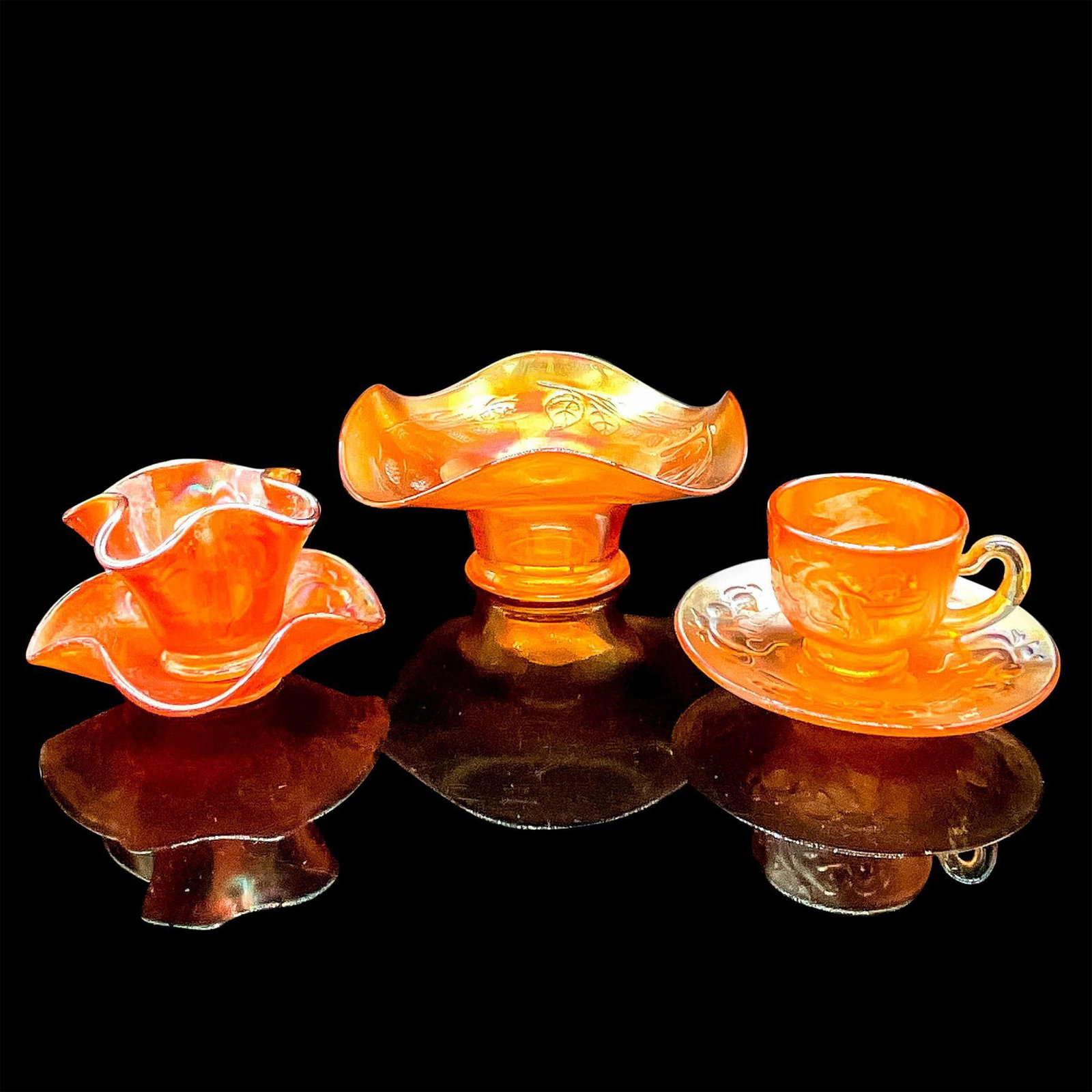 5pc Marigold Fenton Glass, Cup, Bowl, Saucers, Candy Dish: Carnival Glass in hues of orange with leaves motif on candy dish and kitten motif on the others. Demitasse cup and saucer. Curled edge small bowl 2.5"H x 3.5"dia and saucer 1.25"H x 4.5"dia. Candy dis