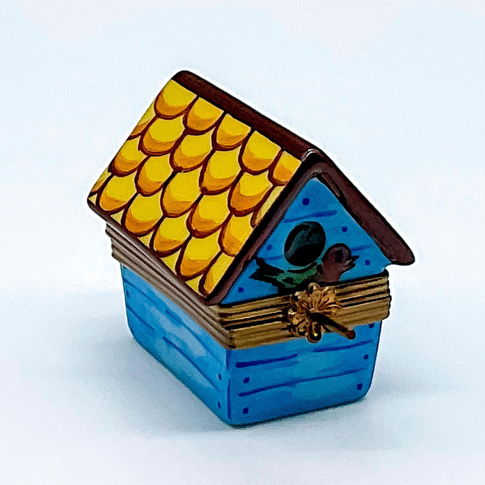 Eximious Limoges Porcelain Birdhouse Box: Hand painted box formed as a blue birdhouse. Music notes painted inside the box. Eximious Limoges France Peint Main marked on the base. Issued: 20th century Dimensions: 2"L x 1.25"W x 1.5"H Manufactur