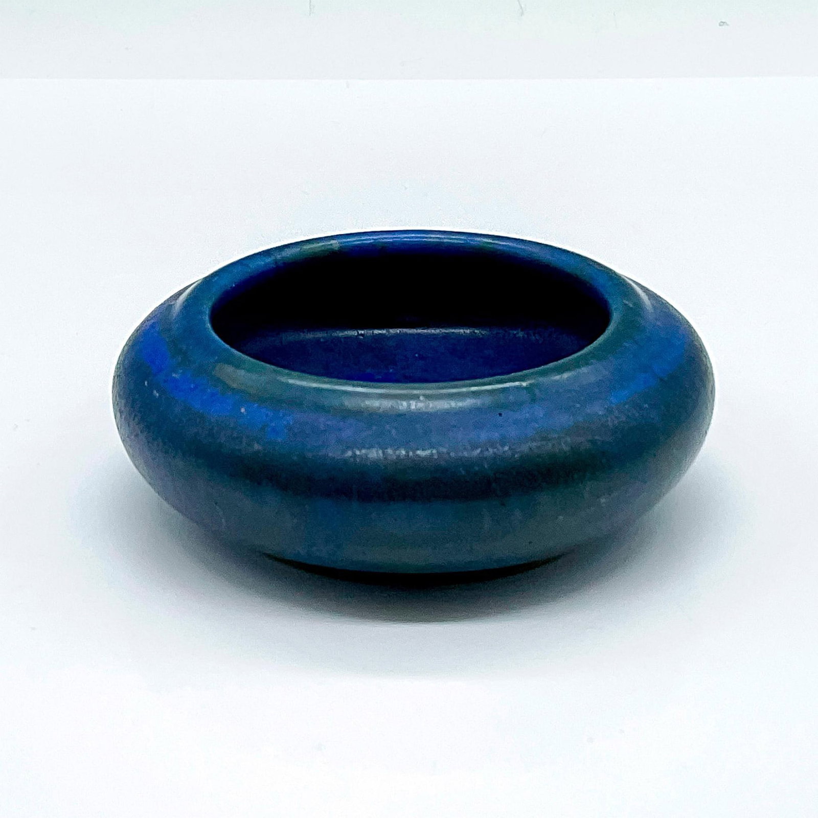 Vintage Fulper Pottery Blue Bowl: Matte cobalt blue trinket bowl with black blemishes. Fulper mark on the base. Dimensions: 4"W x 1.5"H Manufacturer: Fulper Pottery Country of Origin: United States
