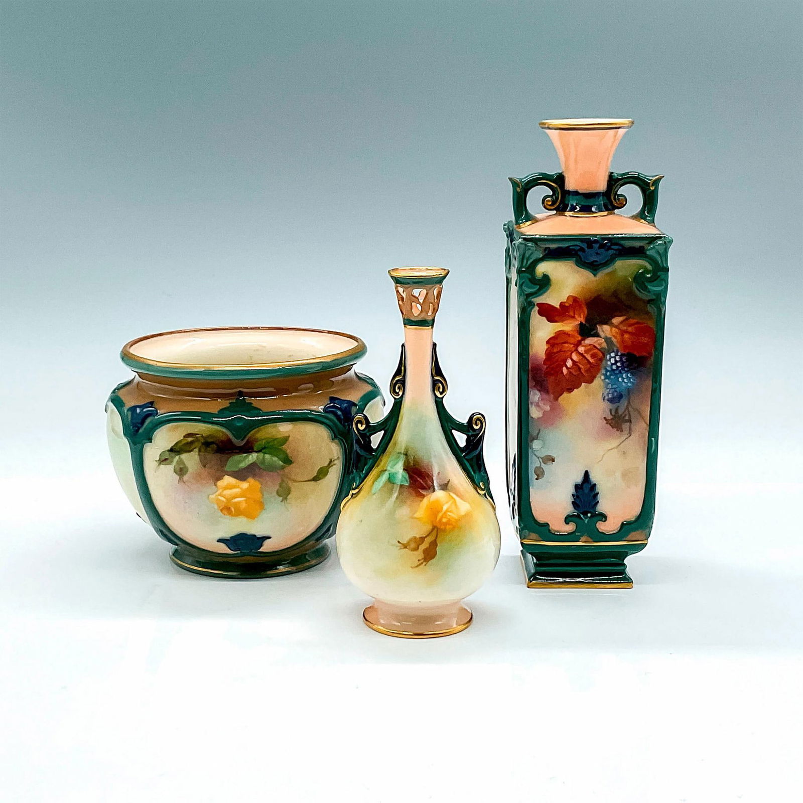 3pc Royal Worcester Porcelain Vases: 3 small floral and fruit motif vases with green accents and gild trims. Royal Worcester backstamps. Vase 1: 2"L x 2"W x 6.5"H. Vase 2: 2.25"L x 2.25"W x 4.75"H. Vase 3: 4.25"W x 3.25"H. Issued: early
