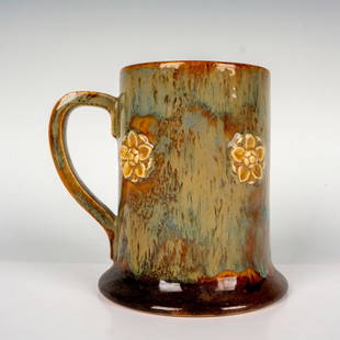 Royal Doulton Stoneware Mug: Glazed Doulton Ware mug with molded white flowers. Blue and brown coloration. Royal Doulton stamped. Artist: Annie Neal Manufacturer: Royal Doulton Country of Origin: England