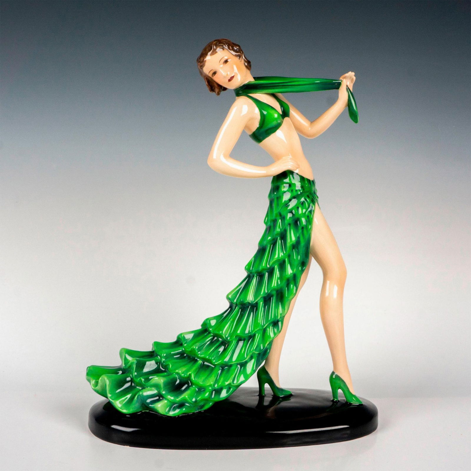 Goldscheider Stefan Dakon Porcelain Sculpture, Rumba: Art Deco figure of a dancer in a green bikini top and a long skirt. Goldscheider stamped. Artist's signature engraved on the underside. Model number 8302 / 16 / 31. Artist: Stefan Dakon Issued: c. 193
