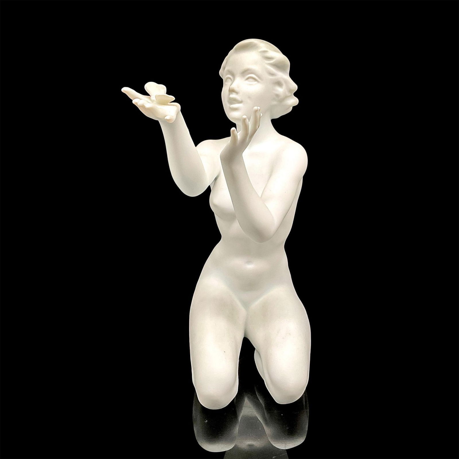 Kaiser Porcelain Nude Sculpture, Girl with Butterfly: Figure of a young girl kneeling and gleefully observing nature. Matte finish. Artist signed. Kaiser backstamp. Issued: 1950 Dimensions: 5"L x 3"W x 7.5"H Manufacturer: Kaiser Country of Origin: German