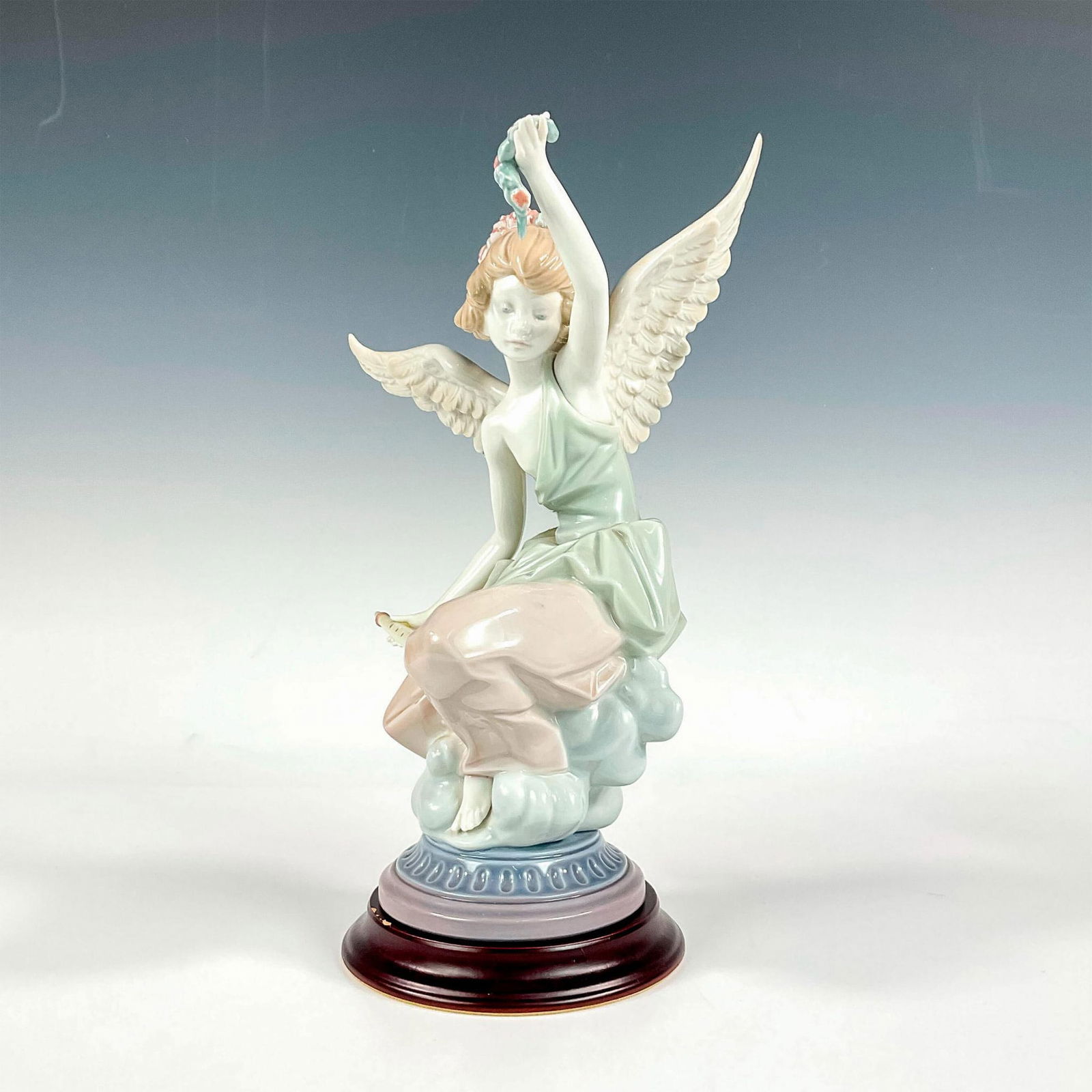 Carefree Angel With Flute 1001463 - Lladro Porcelain Figurine: Glossy finish; Lladro backstamp. Includes a base. Base measures: 4.25" dia. Artist: Salvador Debon Issued: 1985 - 1988 Dimensions: 11.25"H Manufacturer: Lladro Country of Origin: Spain