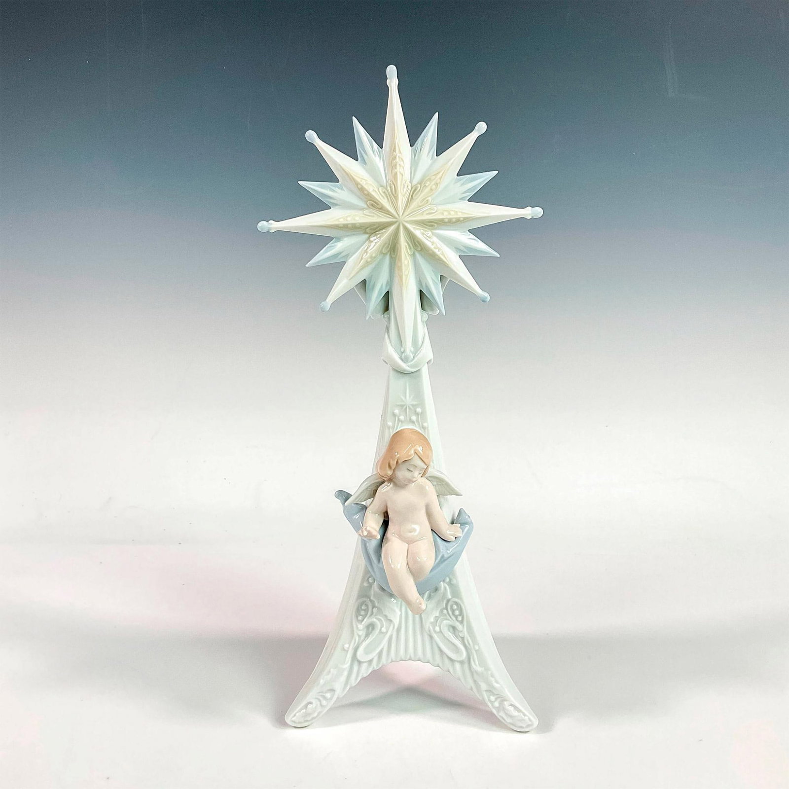 Angelic Light 1006586 - Lladro Porcelain Figurine: Glossy finish; Lladro backstamp. Artist: Francisco Polope Issued: 1998 - 2001 Dimensions: 13"H x 5.5"W Manufacturer: Lladro Country of Origin: Spain