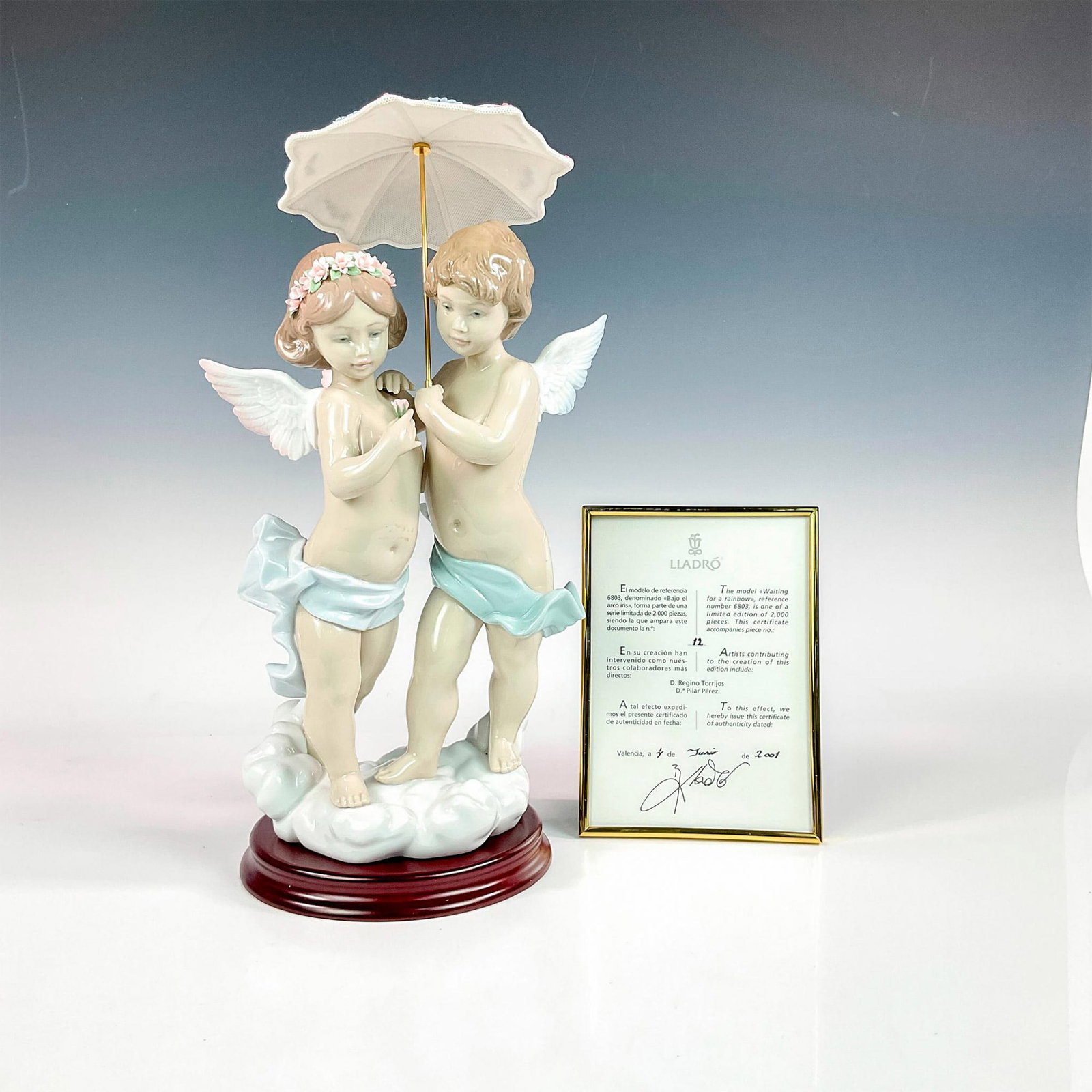 Waiting For A Rainbow 1006803 - Lladro Porcelain Figurine: Glossy finish; Lladro backstamp. Includes original box measuring 19"L x 10.5"W x 12"H. Includes certificate of authentication. Includes base measuring 6.5" dia. x 1"H. Artist: Regino Torrijos Issued: 