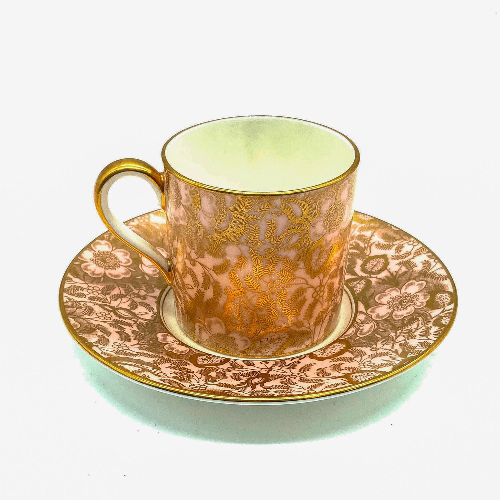 Minton Pink Brocade Demitasse & Saucer Set: Minton bone china pink and gold brocade pattern. Numbered and initialed by artist on bottoms. Saucer: 5"dia. Cup: 3.25"L x 2.25"W x 2.25"H. Manufacturer: Minton Country of Origin: England