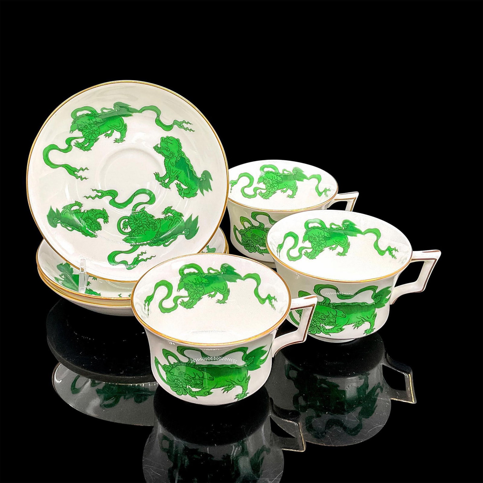 6pc Wedgwood Tea Cups and Saucers, Chinese Tigers: White bone china decorated with green creatures similar to foo dogs. Six cups 4.5"L x 3.75"W x 2.5"H. Six saucers 1.25"H x 5.75"dia. Wedgwood backstamp. Manufacturer: Wedgwood Country of Origin: Engla