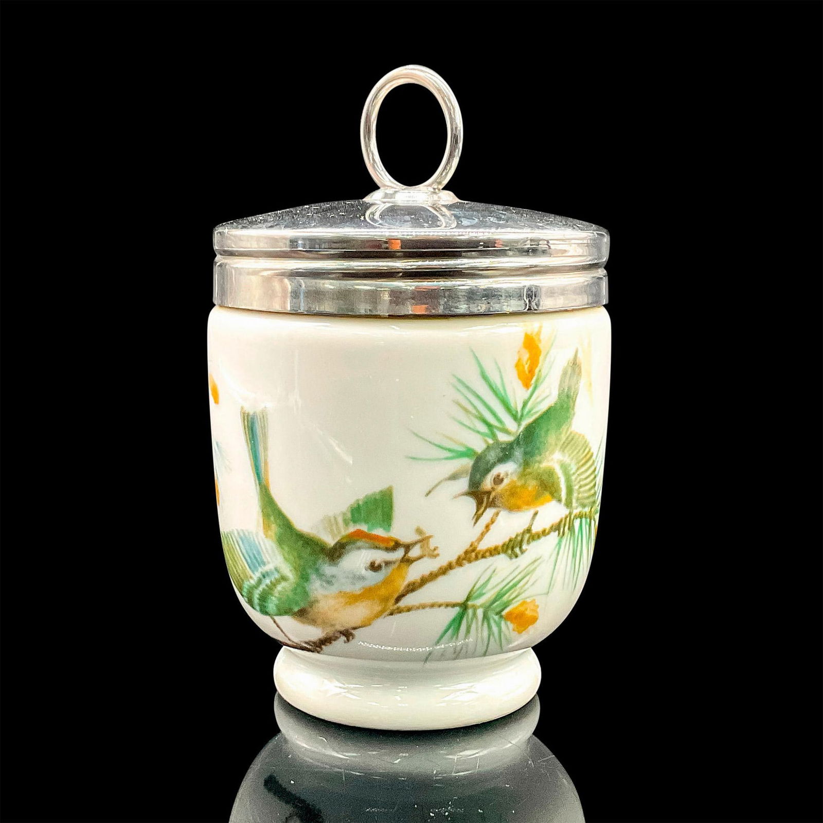 Royal Worcester Egg Coddler, Playful Birds: White porcelain oven-safe egg cup with silvertone lid and active birds motif. Royal Worcester backstamp. Dimensions: 4.25"H x 2.5"dia Manufacturer: Royal Worcester Country of Origin: England
