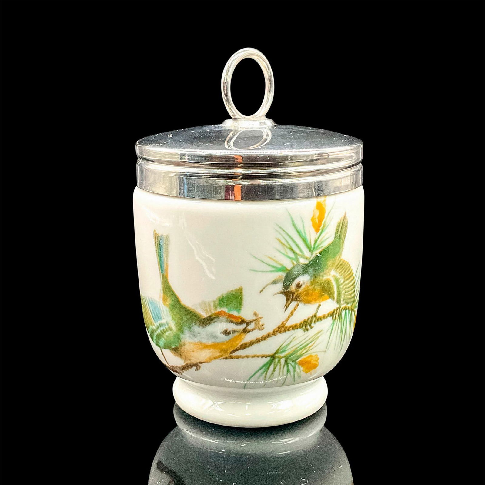 Royal Worcester Egg Coddler, Playful Birds: White porcelain oven-safe egg cup with silvertone lid and active birds motif. Royal Worcester backstamp. Dimensions: 4.25"H x 2.5"dia Manufacturer: Royal Worcester Country of Origin: England