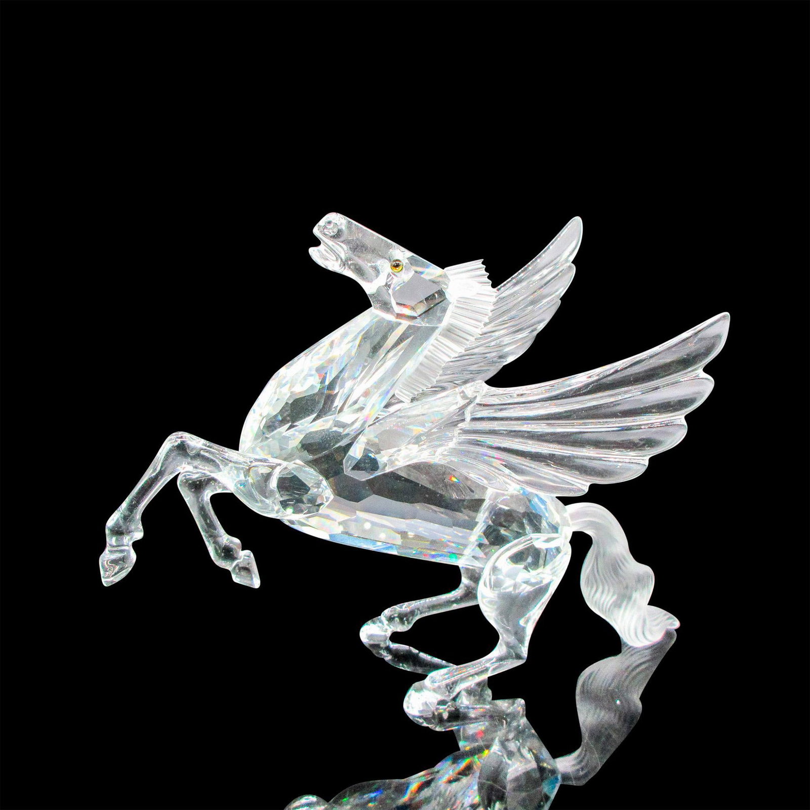 Swarovski Crystal Figurine, 1998 Fabulous Creatures Pegasus: Clear crystal with amber colored eyes. This item has its original box: 10"L x 10"W x 5"H. Certificate of Authenticity included. Dimensions: 5.5"L x 2"W x 5"H Manufacturer: Swarovski Country of Origin: