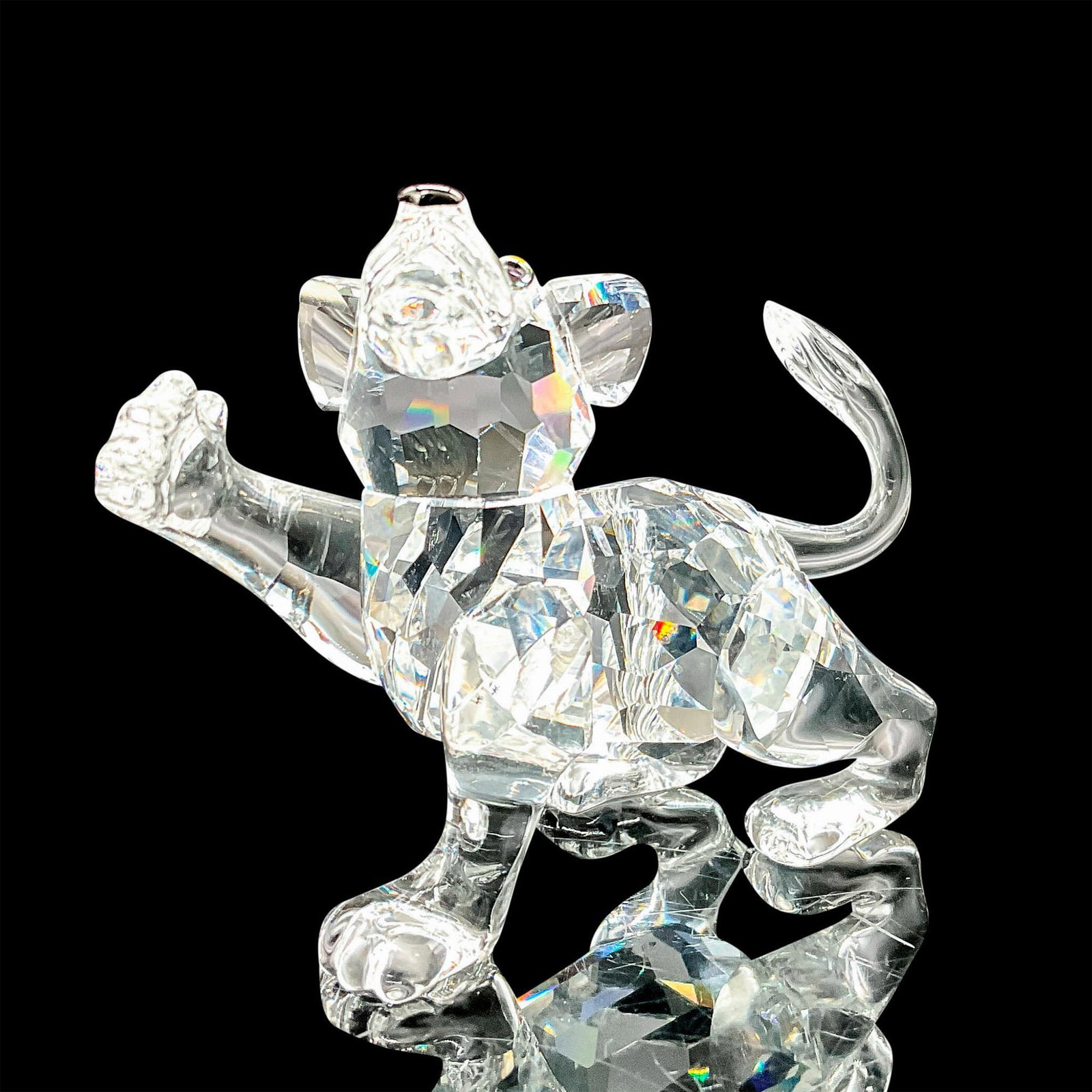 Swarovski Crystal Figurine, Lion Cub 210460: Part of the African Wildlife collection. Lead crystal adorable cub with jet crystal eyes and nose. Swarovski etched backstamp. Artist: Adi Stocker Issued: 1997-2004 Dimensions: 2.5"W x 2"H Manufacture