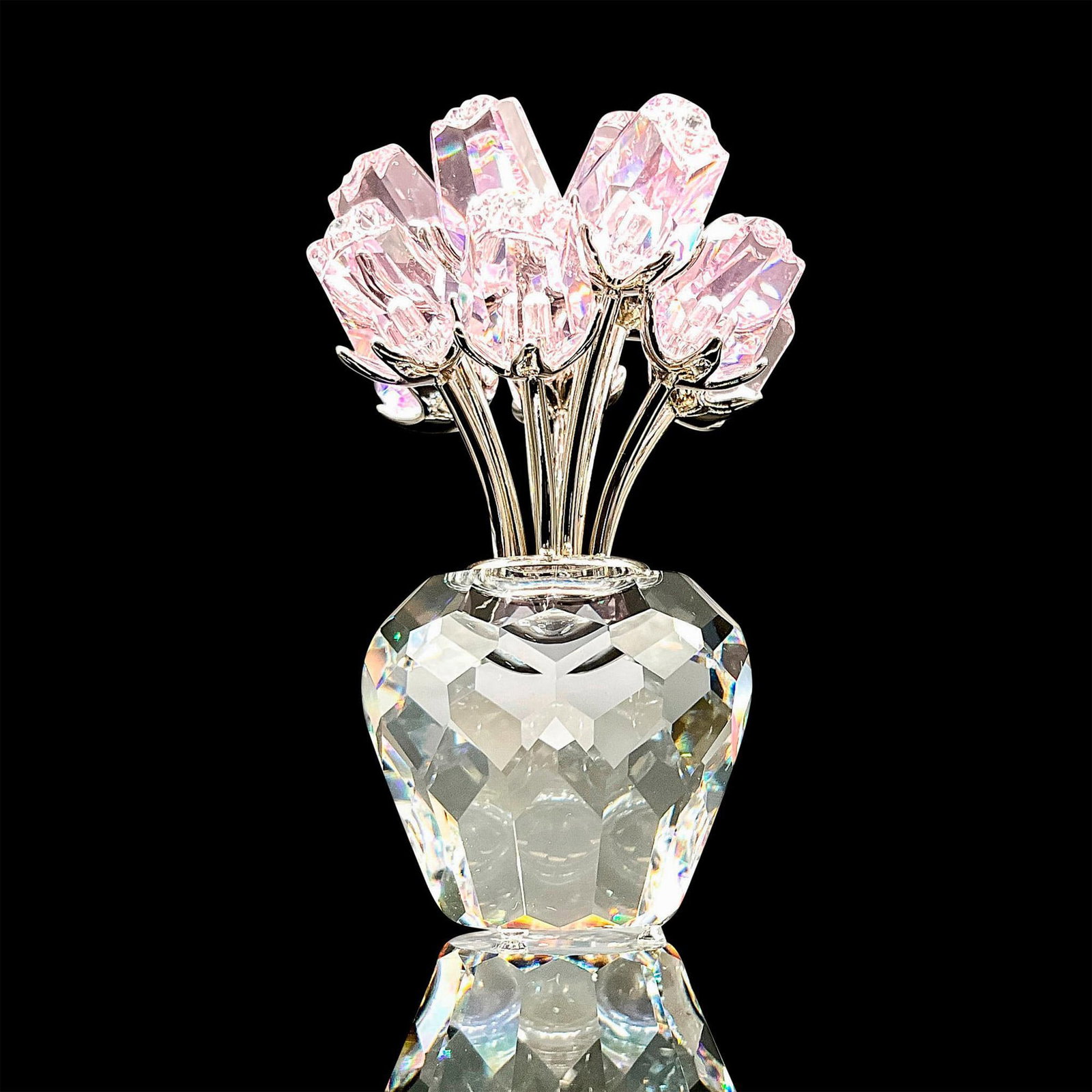 Swarovski Silver Crystal Figurine, A Dozen Pink Roses: Gorgeous faceted crystal figurine modeled as a vase bursting with gem studded pink roses. Swarovski acid marks. This item has its original box. Box dimensions: 4.5"H x 3.25"dia. Dimensions: 1.75"L x 1