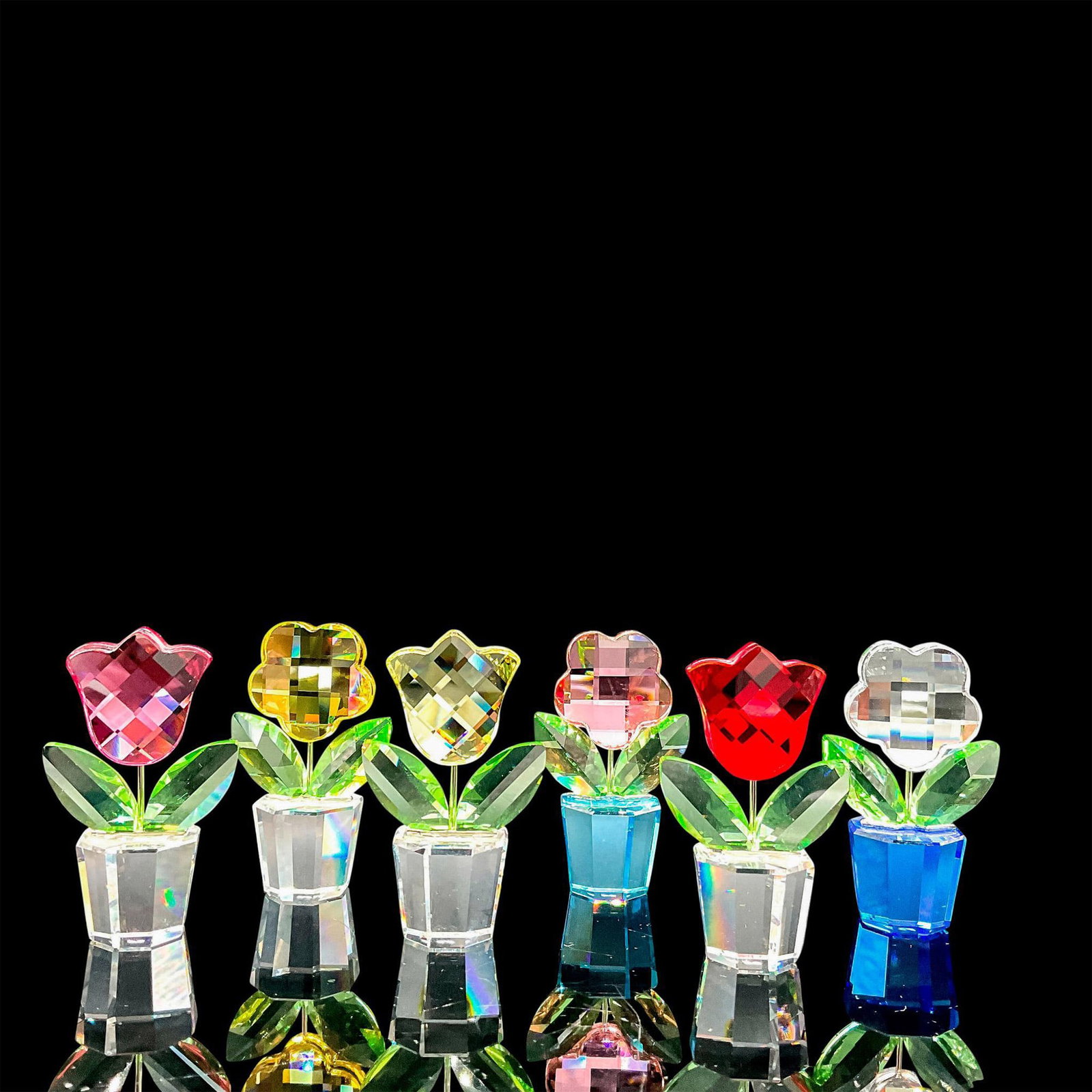 6pc Flowers Colorful Display - Swarovski Crystal Figurines: Lead crystal beautiful mini flowers in pots made with yellow, pink, red, and clear crystals. Swarovski etched backstamp. Artist: Swarovski Team Issued: 2006-2008 Dimensions: 2"H Manufacturer: Swarovsk