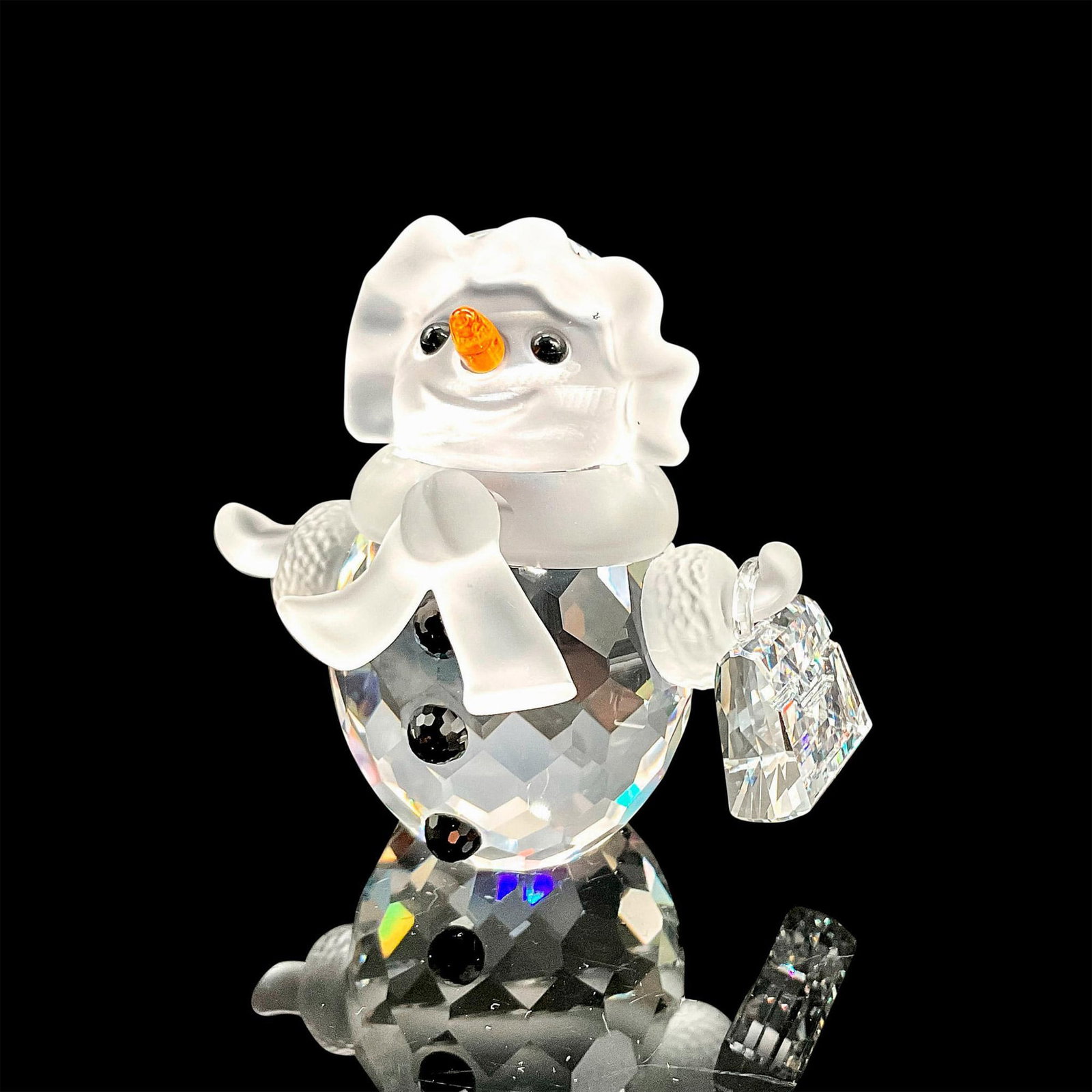 Swarovski Crystal Figurine, Snow Woman: Adorable faceted crystal figurine modeled as a smiling snow woman holding a little purse. Black gem buttons, orange nose, and frost finished details. Swarovski acid marks. This item has its original b