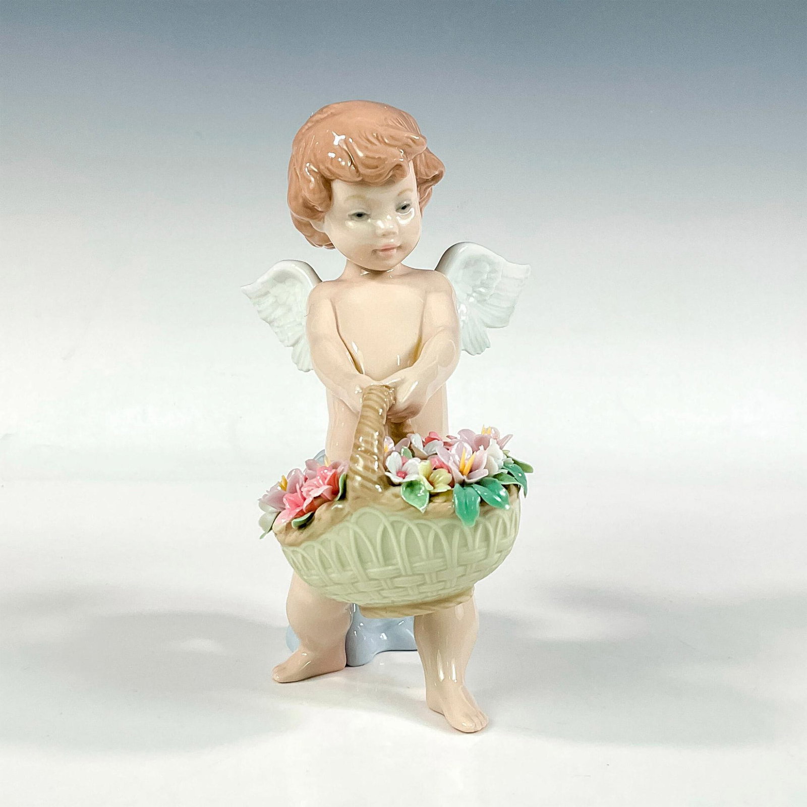 Heaven's Harvest 1006772 - Lladro Porcelain Figurine: Glossy finish; Lladro backstamp. Artist: Regino Torrijos Issued: 2001 - 2007 Dimensions: 6.75"H x 5.5"W Manufacturer: Lladro Country of Origin: Spain