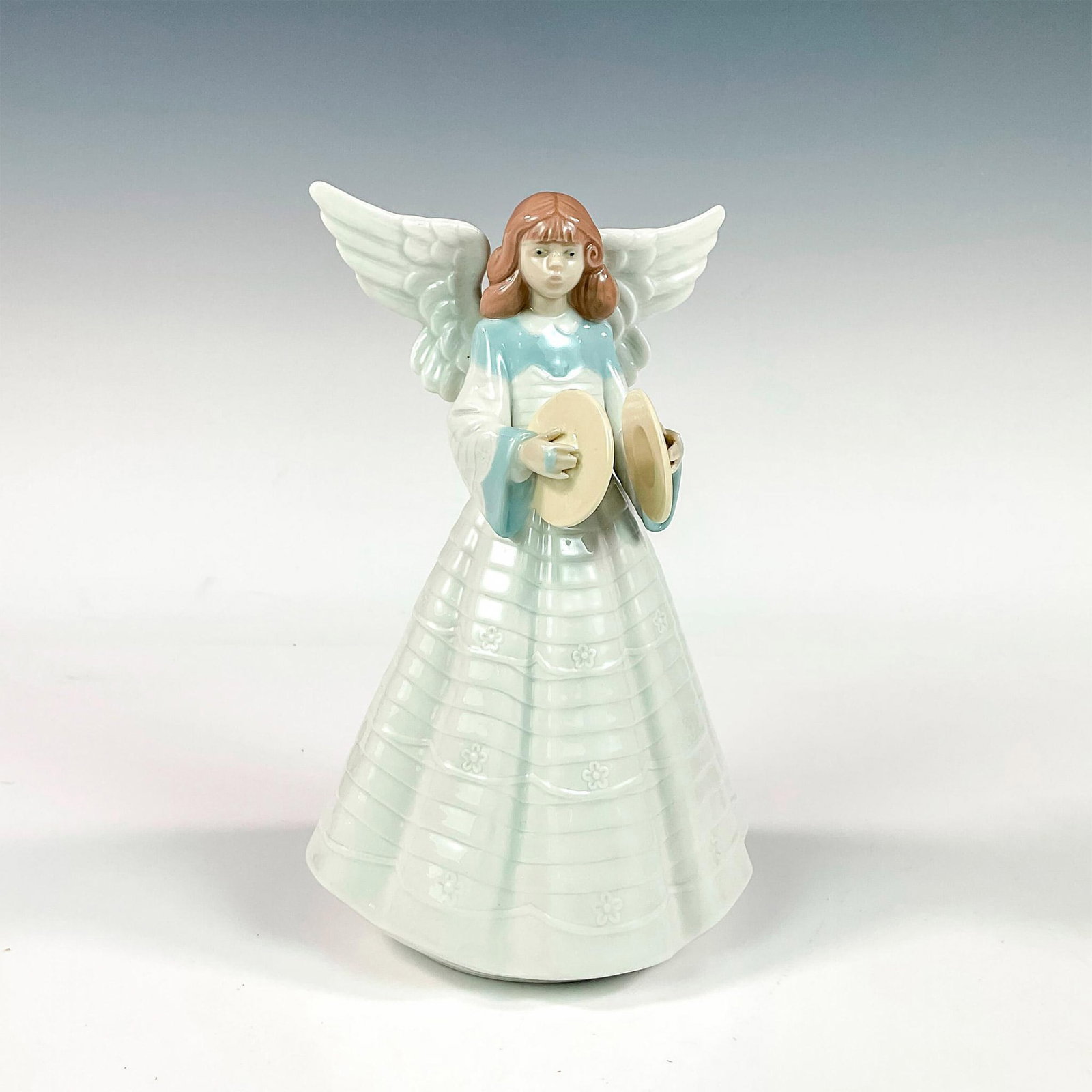 Angelic Cymbalist 1005876 - Lladro Porcelain Figurine: Glossy finish; Lladro backstamp. Includes original box measuring 7.5"L x 12.75"W x 6"H. Artist: Francisco Catala Issued: 1992 - 1992 Dimensions: 7"H Manufacturer: Lladro Country of Origin: Spain