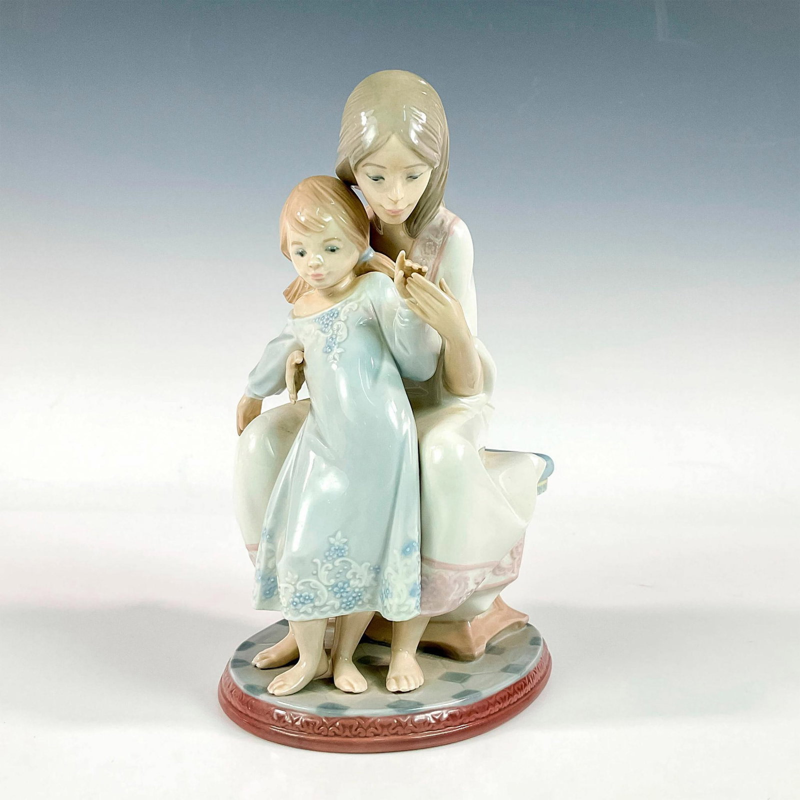 Tenderness 1001527 - Lladro Porcelain Figurine: Glossy finish; Lladro backstamp. Artist: Juan Huerta Issued: 1987 - 2004 Dimensions: 8.75"H x 5.5"W Manufacturer: Lladro Country of Origin: Spain