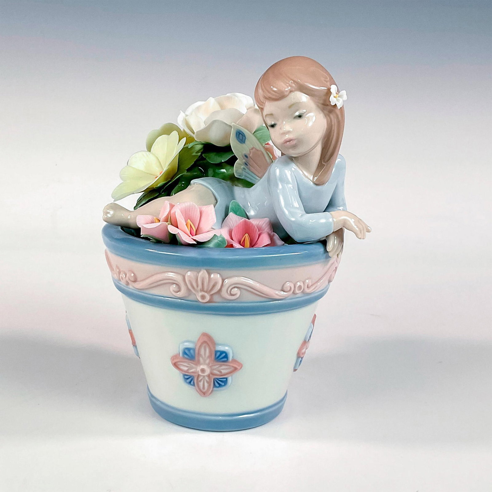 Butterfly Fantasy 1001846 - Lladro Porcelain Figurine: Glossy finish; Lladro backstamp. Artist: Julio Fernandez Issued: 1999 - 2002 Dimensions: 7.5"H x 5"W Manufacturer: Lladro Country of Origin: Spain