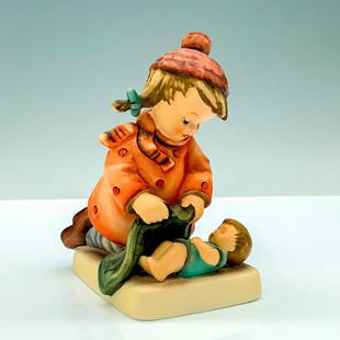 Goebel Hummel Porcelain Figurine, Sleep Tight: A figure of a young girl in a red jacket and hat tucking in her younger sibling with a blanket. Goebel Hummel backstamp. Issued: 20th Century Dimensions: 3.75"L x 2.75"W x 4.5"H Manufacturer: Goebel H