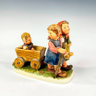 Goebel Hummel Porcelain Figurine, Pleasant Journey 406: Part of the Century Collection. Ceramic figures of two girls and a boy in wooden cart. Hummel impressed mark. Goebel backstamp. Certificate of Authenticity included. Issued: 1979 - 1990 Dimensions: 7.