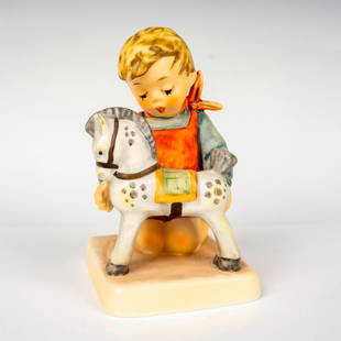 Goebel Hummel Figurine, Horse Trainer: Hand painted in matte finish modeled as a young boy playing with his rocking horse. M. I. Hummel impressed backstamp. Goebel backstamp. Dimensions: 3"L x 3.5"W x 5"H Manufacturer: Goebel Hummel Countr