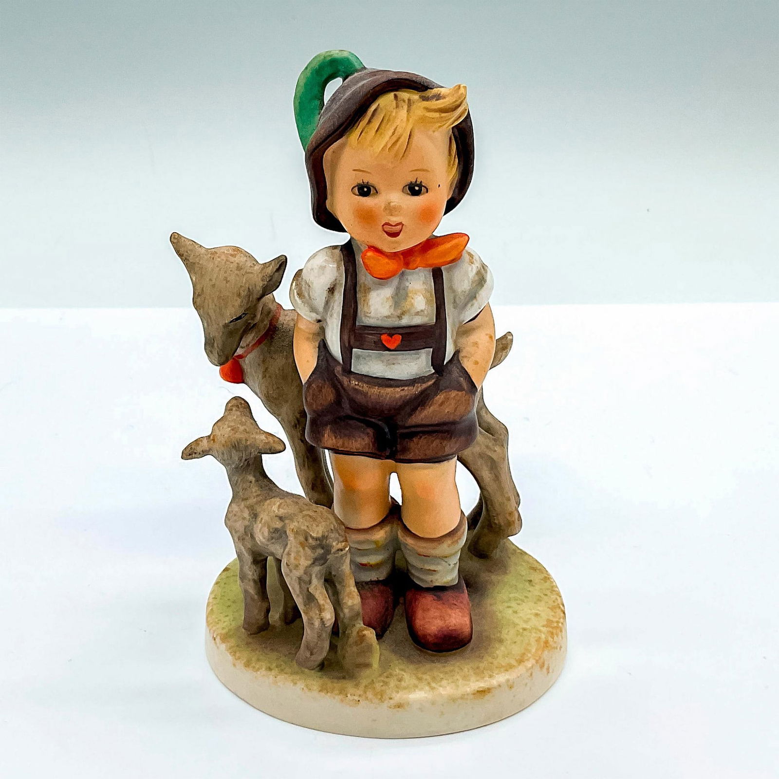 Goebel Hummel Porcelain Figurine, Little Goat Herder: Hand painted figure of a young boy with his goats. Goebel Hummel backstamp. HUM 200/1. Issued: c. 1964-1972 Dimensions: 3.5"L x 3"W x 5.25"H Manufacturer: Goebel Hummel Country of Origin: Germany