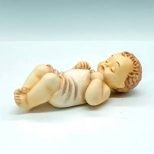 Goebel Hummel Figurine Baby Jesus Blessed Child: Bisque porcelain figurine of the baby Jesus sleeping. TMK7 Figure #78. Goebel backstamp and MI Hummel impressed stamp. Issued: 1990-1999 Dimensions: 5"L x 2.5"W x 1.5"H Manufacturer: Goebel Hummel Cou