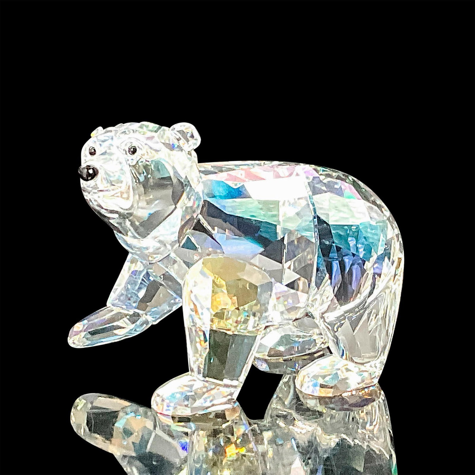 Swarovski Crystal SCS Figurine, Polar Bear Cub, Moonlight: This cub is fully faceted Crystal Moonlight with Jet crystal eyes and nose. Swarovski etched backstamp. Artist: Anton Hirzinger Issued: 2011 Dimensions: 2.75"L x 1.5"W x 2"H Manufacturer: Swarovski C