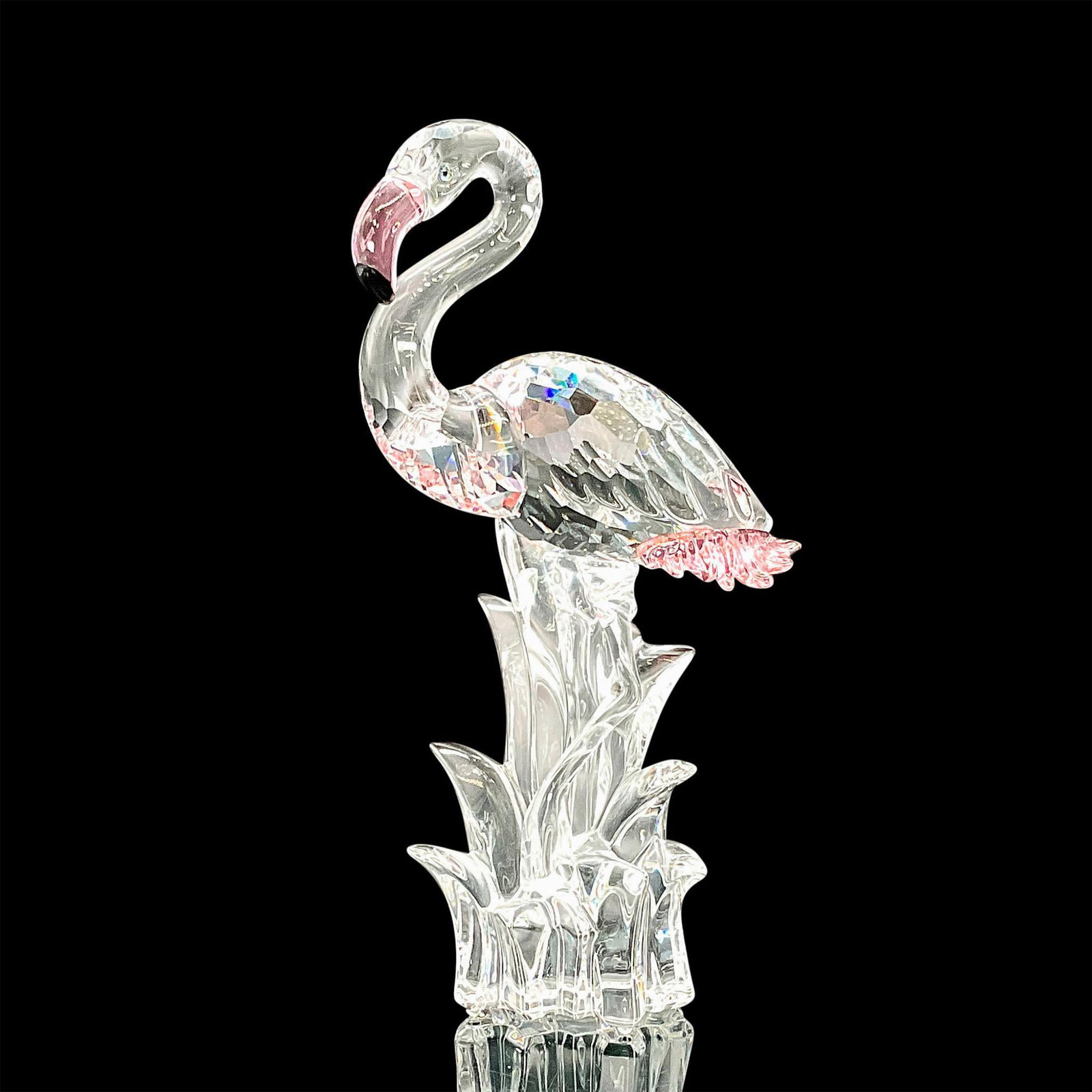 Swarovski Crystal Figurine, Flamingo: This crystal Flamingo was part of the Feathered Beauties collection. Its body comes in faceted clear crystal with unfaceted clear crystal neck, head, legs and water. The feathers have Rosaline crystal