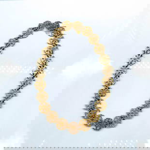 Yves Saint Laurent Rive Gauche Floral Gold Chain Belt: Comprised of 23 flower medallions and a hook clasp closure. Signed Yves Saint Laurent hang tag. Dimensions: 30"L Manufacturer: Yves Saint Laurent Country of Origin: France