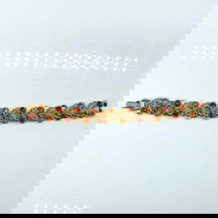 Coro Silver Feathers and Colored Rhinestones Bracelet: Red and orange rhinestones with silver tone feathers. Coro mark on clasp. Dimensions: 7"L Manufacturer: Coro