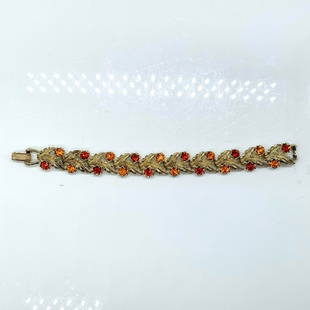 Coro Silver Feathers and Colored Rhinestones Bracelet: Red and orange rhinestones with silver tone feathers. Coro mark on clasp. Dimensions: 7"L Manufacturer: Coro