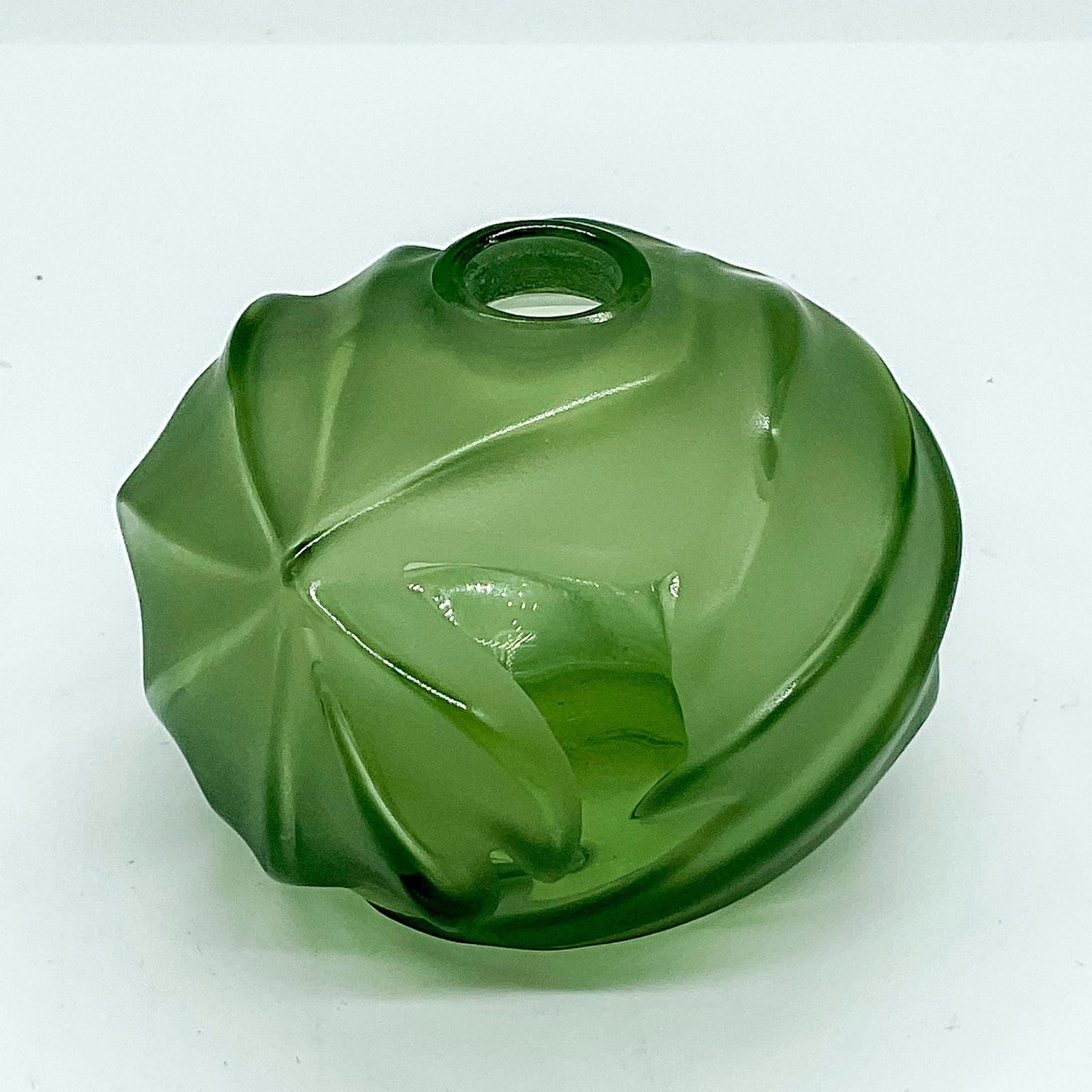 Lalique Crystal Small Sage Bud Vase: A round clear and frosted green vase with a swirl pattern. Lalique France etched on base. Dimensions: 2.75"W x 2"H Manufacturer: Lalique Country of Origin: France Provenance: Collection of Marie-Claud