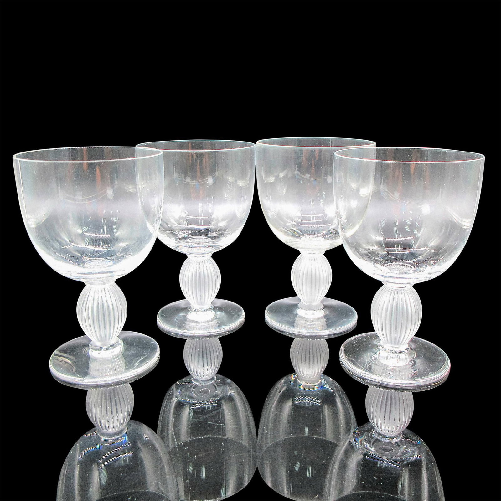 Marc Lalique (French, 1900-1977) Crystal Bordeaux Wine Glasses, Langeais: 4pc. Clear body with frosted vertical ribbed stem. Lalique etched mark. Artist: Marc Lalique (French, 1900-1977) Dimensions: 3"L x 3"W x 4.75"H Manufacturer: Lalique Country of Origin: France Provena