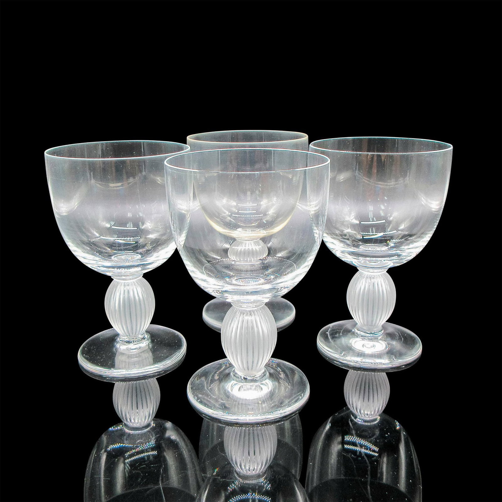 Marc Lalique (French, 1900-1977) Crystal Bordeaux Wine Glasses, Langeais: 4pc. Clear body with frosted vertical ribbed stem. Lalique etched mark. Artist: Marc Lalique (French, 1900-1977) Dimensions: 3"L x 3"W x 4.75"H Manufacturer: Lalique Country of Origin: France Provena