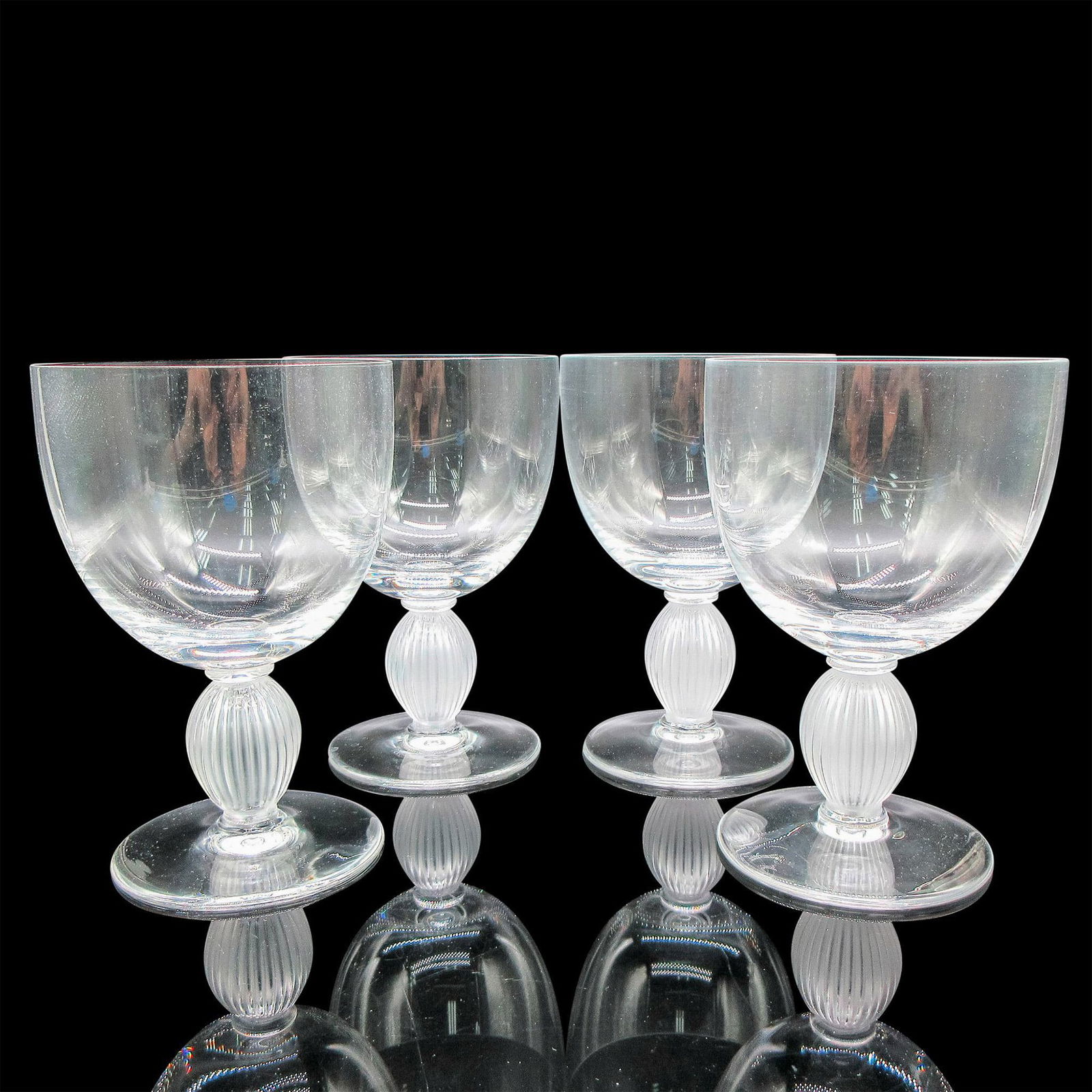 Marc Lalique (French, 1900-1977) Crystal Water Goblets, Langeais: 4pc. Clear body with frosted vertical ribbed stem. Lalique etched mark. Artist: Marc Lalique (French, 1900-1977) Dimensions: 4"L x 4"W x 6"H Manufacturer: Lalique Country of Origin: France Provenance