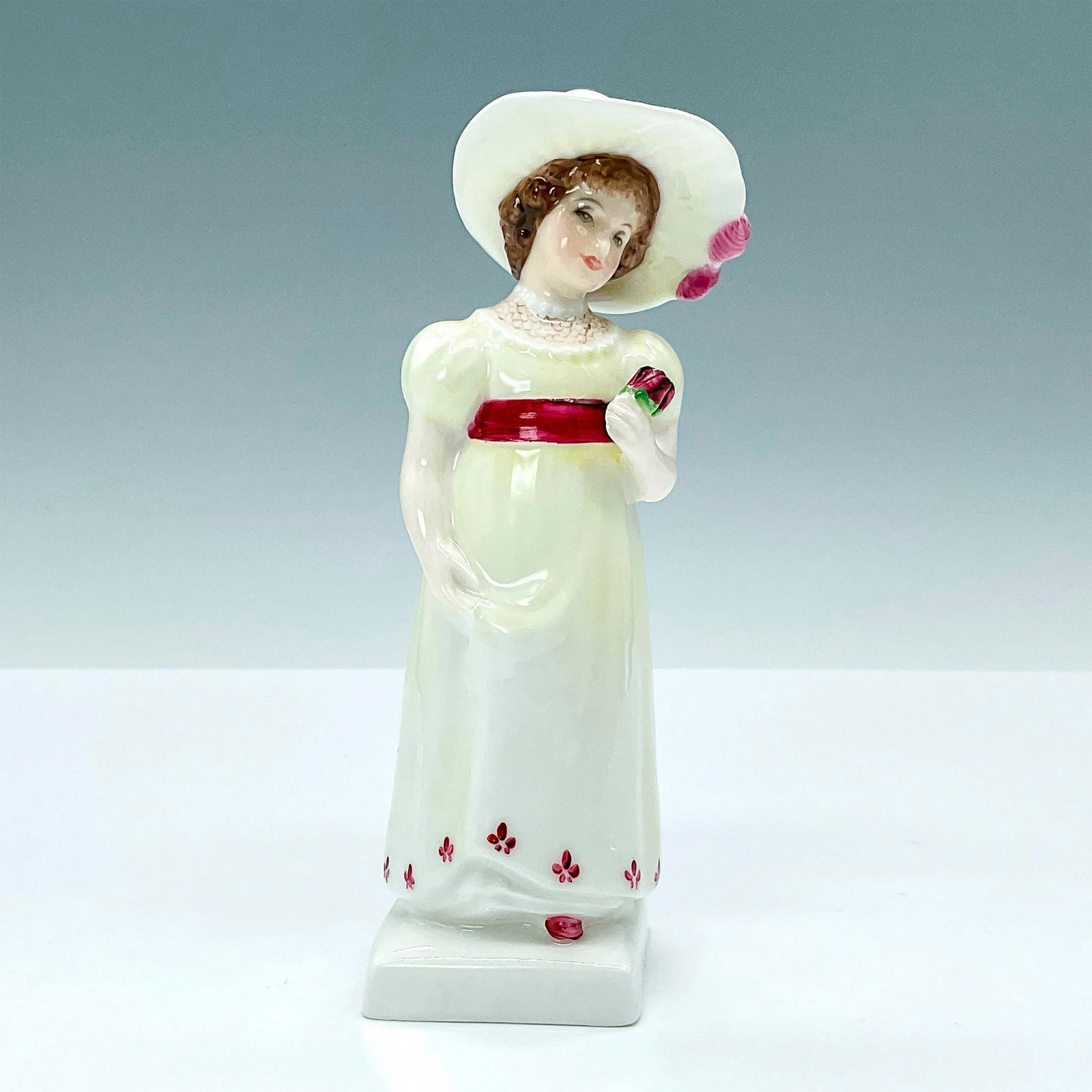 Lori HN2801 - Royal Doulton Figurine: Kate Greenaway series, modeled as woman wearing yellow dress holding roses. Royal Doulton backstamp. Artist: Peggy Davies Dimensions: 1.75"L x 1.75"W x 6"H Issued: 1976-1987 Manufacturer: Royal Doulto