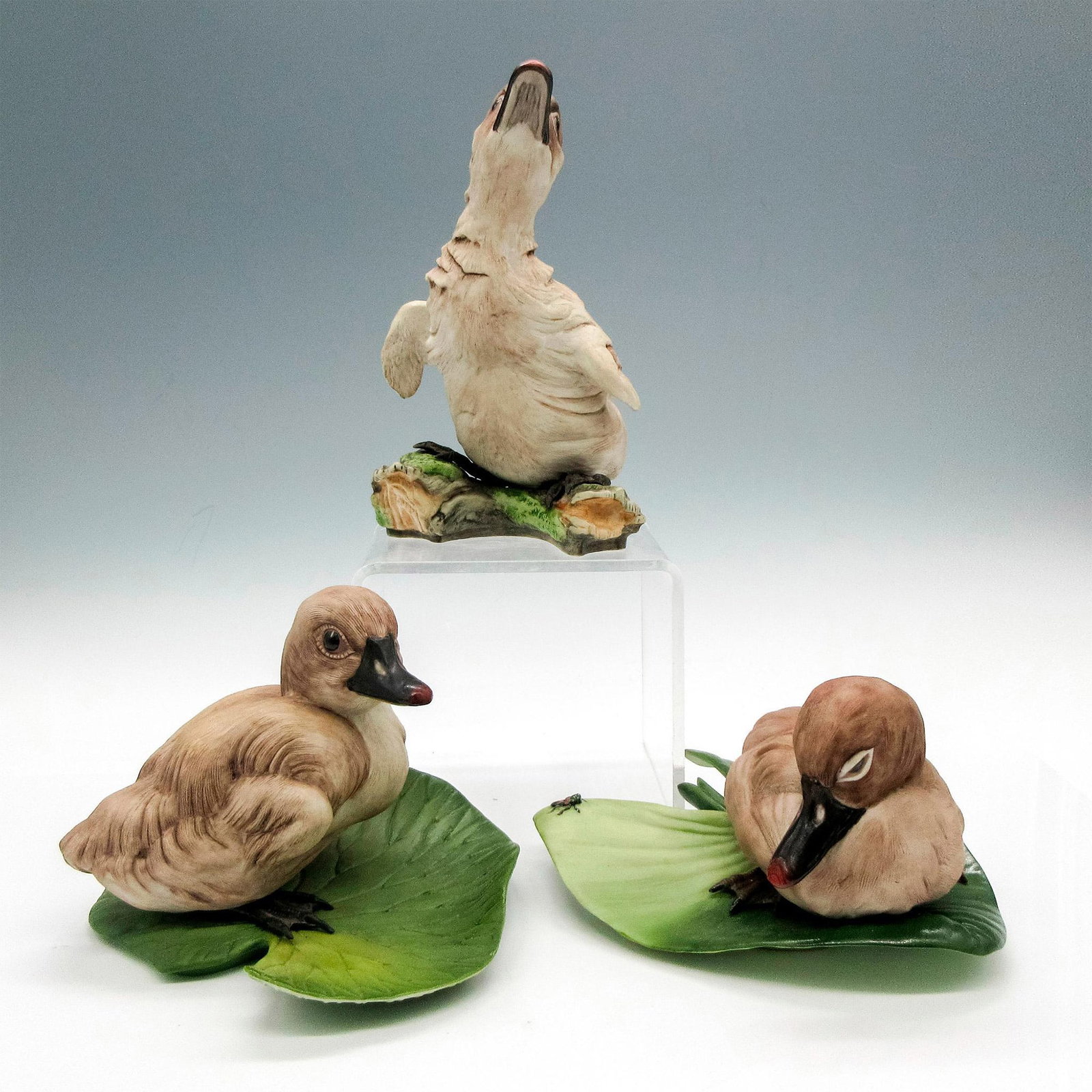 3pc Boehm Porcelain Figurines, Cygnet: Includes beautifully illustrated figures on lily pads and standing pose. Boehm backstamp. Largest piece: 4.25"L x 4.5"W x 6.5"H. Issued: 20th century Manufacturer: Boehm