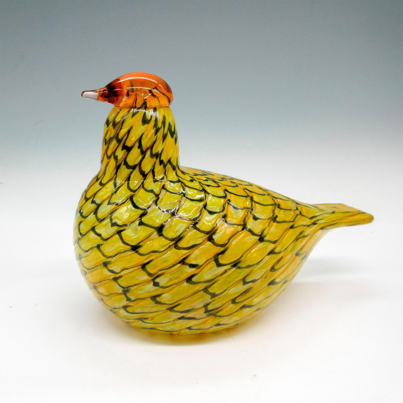 iittala Oiva Toikka Art Glass Bird Figurine, Summer Grouse: Yellow coloration with grey wave design on body. Clear amber colored glass on head. iittala sticker. Oiva Toikka signature on the bottom. Artist: Oiva Toikka Issued: 20th century Dimensions: 6"L x 3.5