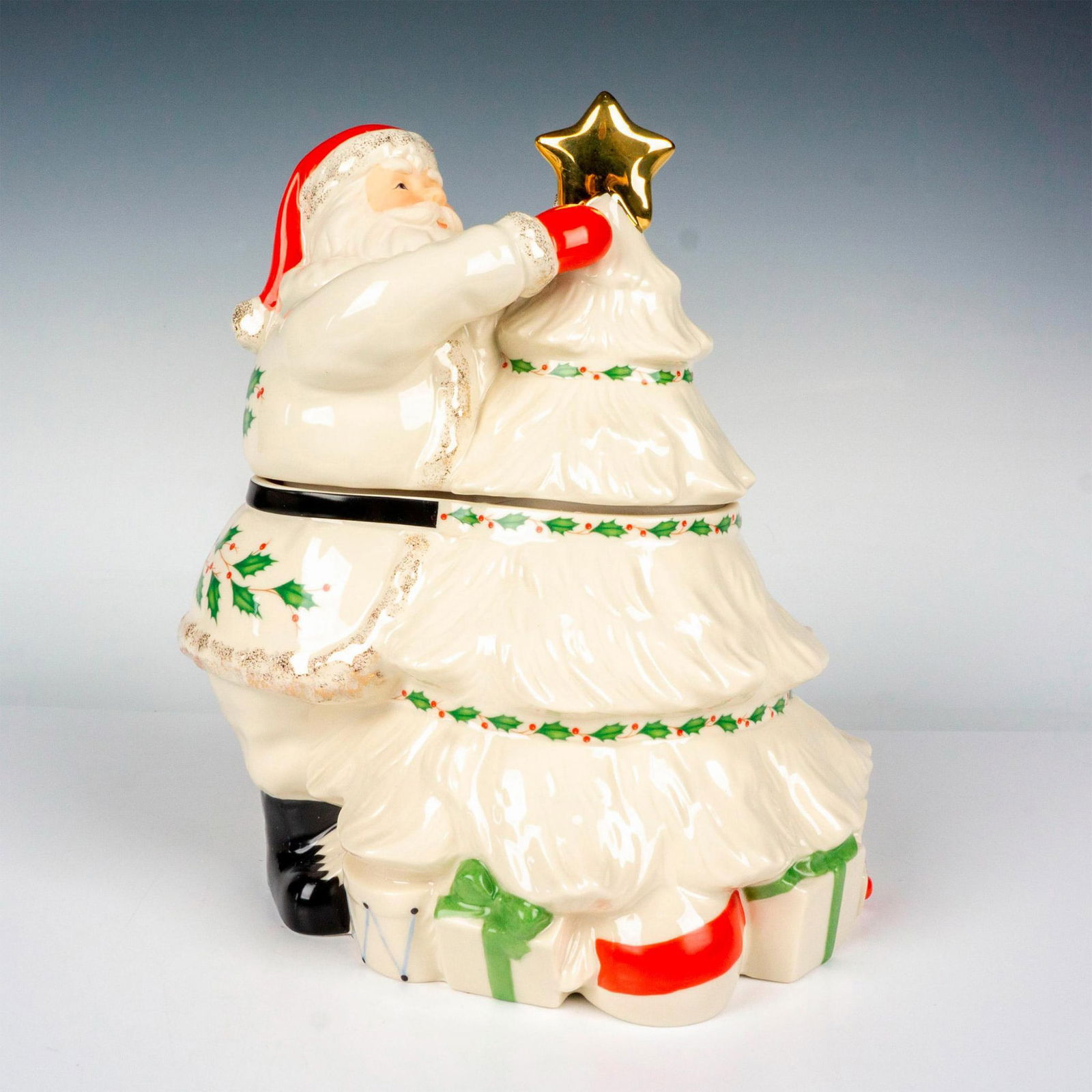 Lenox Porcelain Cookie Jar, Santa: From the Spode Holiday Collection, this elegant porcelain figural cookie jar depicts Santa in all white, gracefully painted and embellished with sparkling glitter and gold gilt. This item has its orig