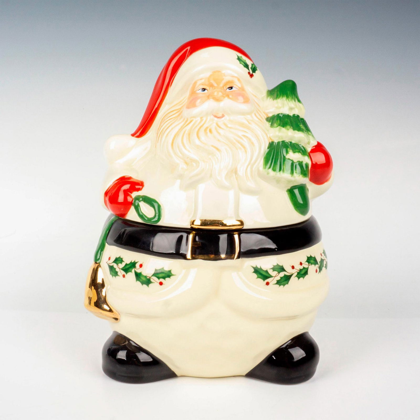 Lenox Porcelain Cookie Jar, Santa with Christmas Tree: Whimsical Santa figurine in a mostly white outfit, embellished with green, red, and black details, adorned with gold gilt accents. Lenox backstamp. This item has its original box which measures 8"L x