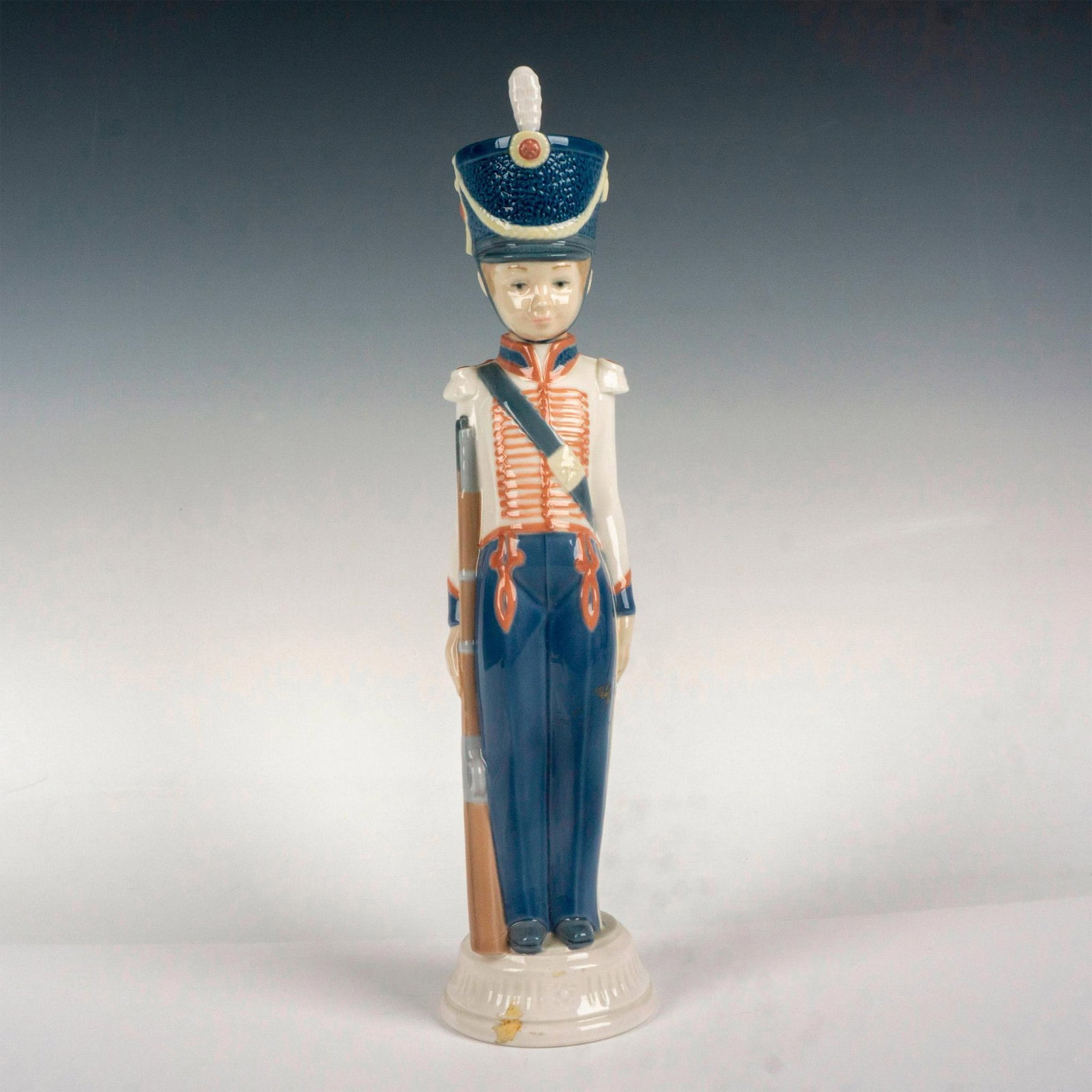 At Attention 1005407 - Lladro Porcelain Figurine: Glossy finish; Lladro backstamp. Artist: Vicente Martinez Issued: 1987 - 1989 Dimensions: 12.5"H Manufacturer: Lladro Country of Origin: Spain