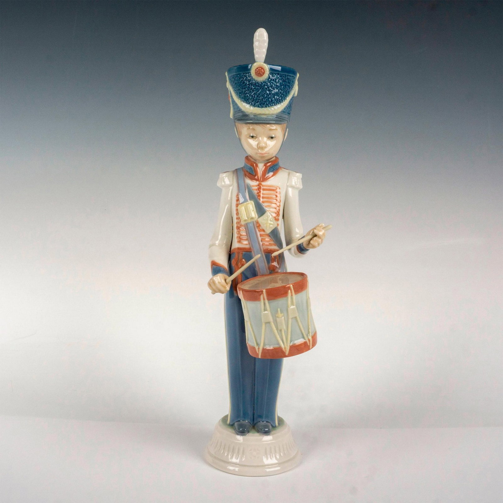 Drummer Boy 1005403 - Lladro Porcelain Figurine: Glossy finish; Lladro backstamp. Artist: Vicente Martinez Issued: 1987 - 1989 Dimensions: 12.5"H Manufacturer: Lladro Country of Origin: Spain