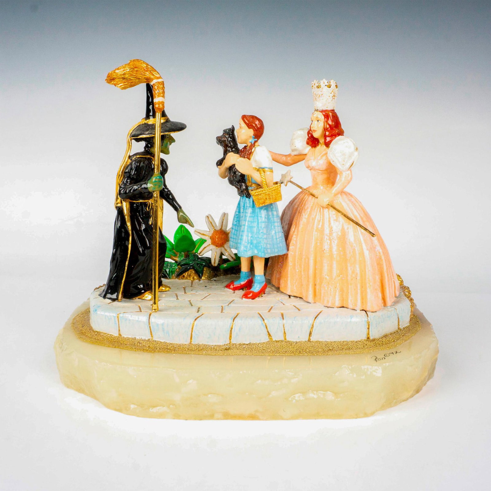 Ron Lee (American 1947-1959), Wizard of Oz Sculpture: A limited edition, hand painted metal featuring Dorothy, Glinda, and The Wicked Witch. Onyx base; heavy gilded decorations. Signed Ron 92 to base. Artist: Ron Lee Issued: 1992 Dimensions: 9.75"L x 7.2