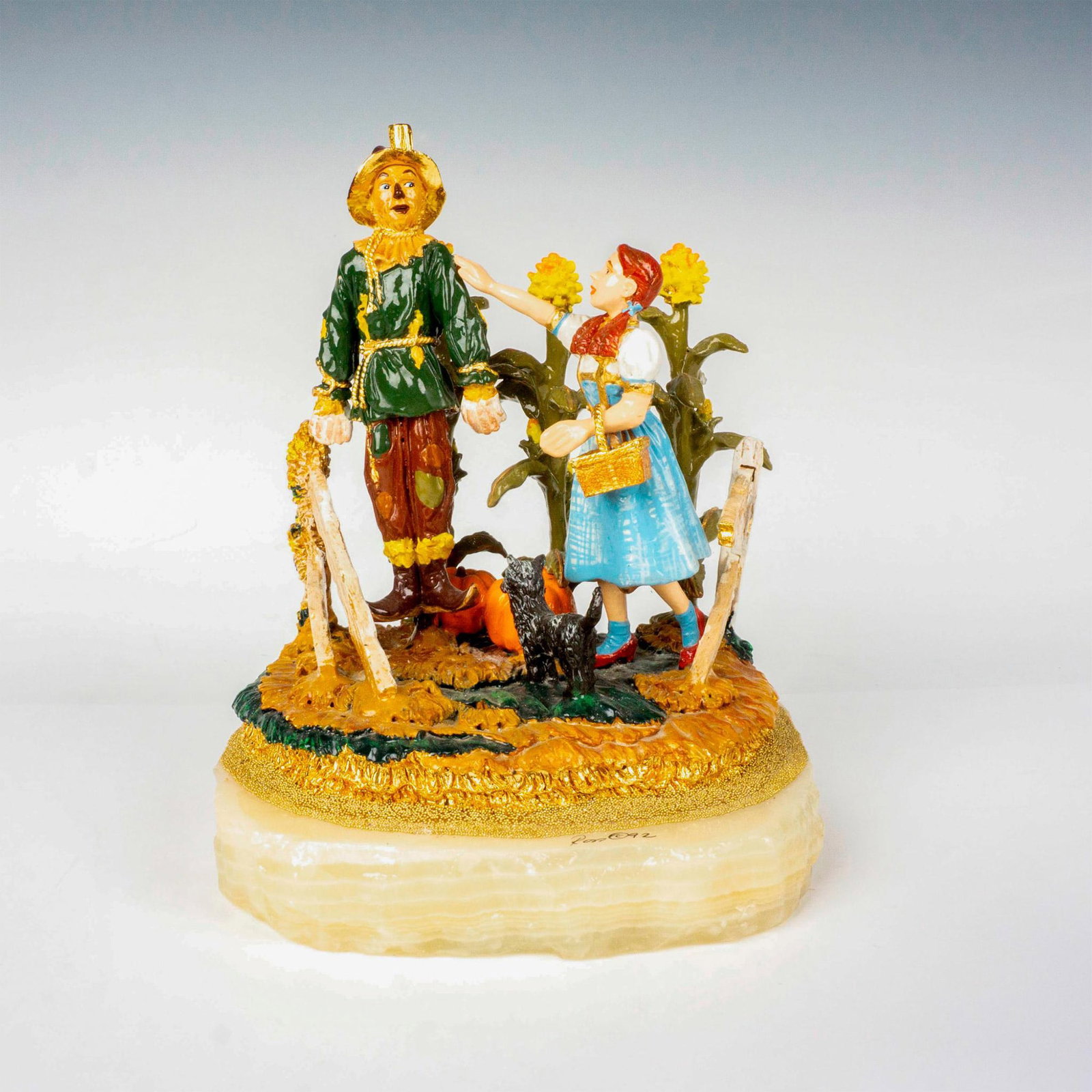 Ron Lee (American 1947-2019), Wizard of Oz Sculpture: A limited edition, hand painted piece featuring Dorothy and Scarecrow scene; highly detailed with gilded touches. Signed Ron 92. Artist: Ron Lee Issued: 1992 Dimensions: 6"L x 6.25"W x 8.5"H Edition N